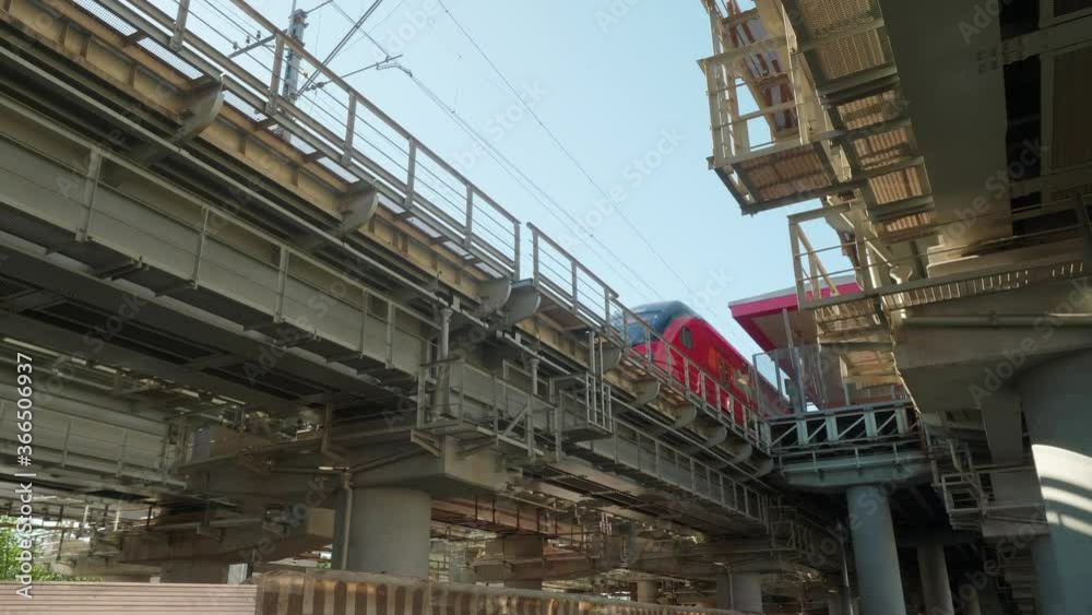 Low angle view of bridge with railways for trains. Train goes from station to station. View from under the bridge. Railways. Low angle view of bridge with railways for trains. Train goes from station to station. View from under the bridge. Railways.