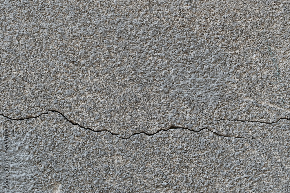 Obraz premium relief concrete wall with deep cracks and scratches