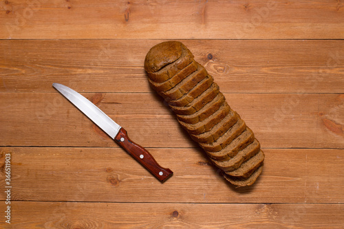 Assortment of baked bread on wooden table background