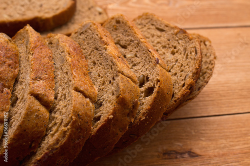 Assortment of baked bread on wooden table background