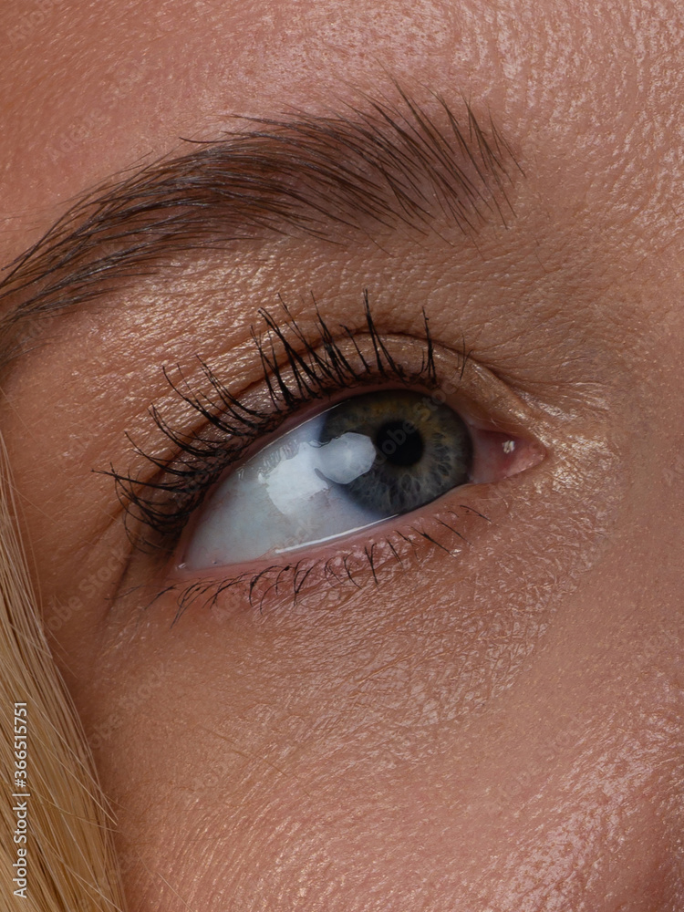 Fototapeta premium Close up view of beautiful brown female eye. Perfect trendy eyebrow. Good vision, contact lenses, brow bar or fashion eyebrow makeup concept. Spa, surgery and cosmetology