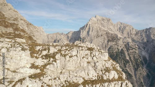 Wallpaper Mural Aerial - Amazing drone shot of a mountain biker standing on the edge of the mountain on a beautiful day. 4K Torontodigital.ca