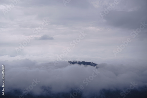 Mountain and cliff edge in the fog of Pha Mo E Dang cliff, Thailand