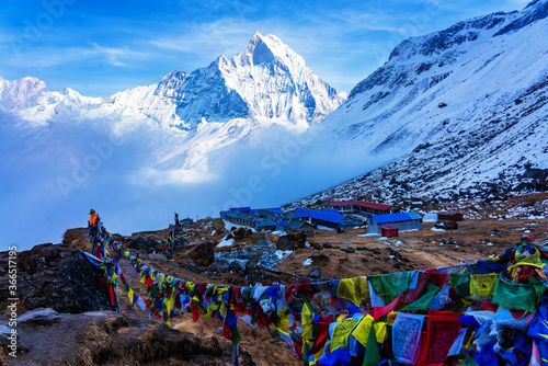 ANNAPURNA BASE CAMP, NEPAL - DEC 1, 2018: Morning view of Mount Annapurna I from Annapurna base camp with prayers flags, round Annapurna circuit trekking trail, Nepal.