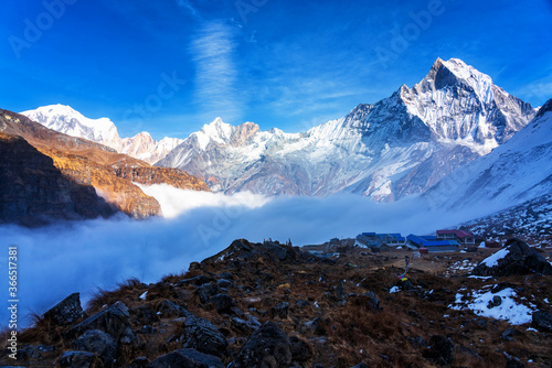 Panorama of Mount Machapuchare (Fishtail) at sunset, view from Annapurna base camp in the Nepal Himalaya. Machhapuchchare is a mountain in the Annapurna Himal of north Central Nepal photo