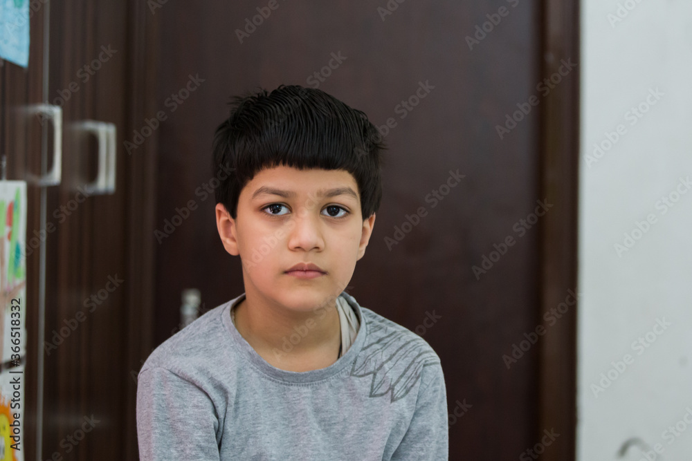 six year old Indian boy showing his grown up hair just before having a haircut six year old Indian boy showing his grown up hair just before having a haircut