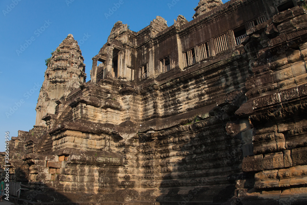 The temple complex of Angkor Watt, Cambodia, early morning sun looking at towers
