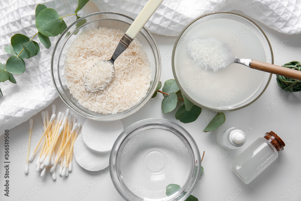 Healthy rice water with cosmetic supplies on white background Healthy rice water with cosmetic supplies on white background