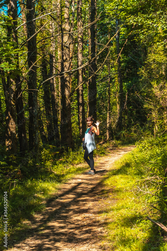 Very happy young girl in the Listorreta natural park in the town of Errenteria in the park of the Peñas de Aya or Aiako Harria park. Gipuzkoa, Basque Country