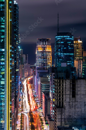 Evening city scene at Ayala Avenue and Makati Skyline, during rush hour. Cityscape of Makati, Metro Manila, Philippines.