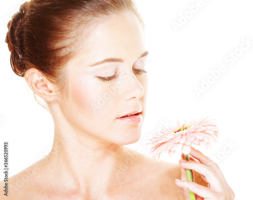 girl with cloused eyes holding flower photo