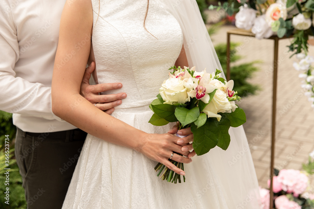 Newlyweds at wedding day, wedding couple with wedding bouquet of flowers, bride and groom Newlyweds at wedding day, wedding couple with wedding bouquet of flowers, bride and groom