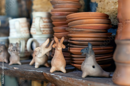 Selective focus on collection of traditional clay pottery old children's toys, whistles in the form of animals