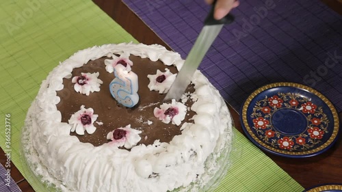 Female hands cutting a piece of cake