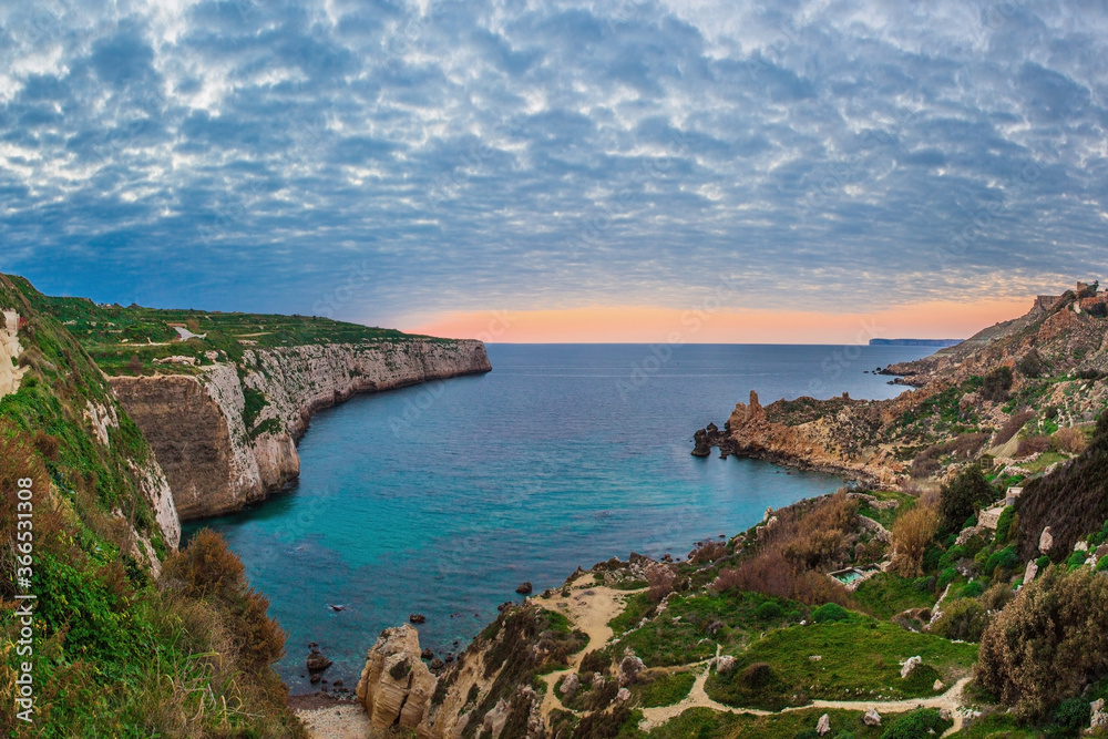 Colourful clouds saturate the background at Fomm ir-Rih, Malta