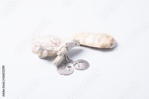 Earrings and coral on a white background
