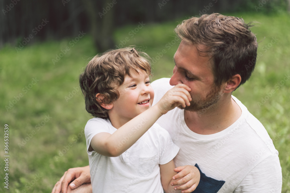 Father and his son playing and hugging in outdoors. Concept of Father's day. Father and his son playing and hugging in outdoors. Concept of Father's day.