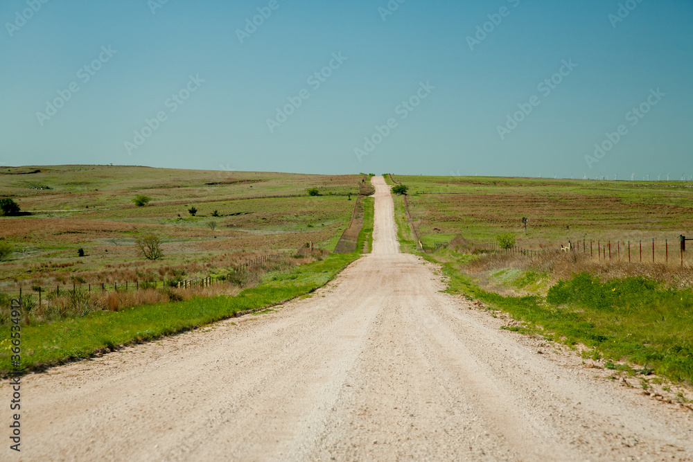 A gravel road through range land in the Oklahoma panhandle.