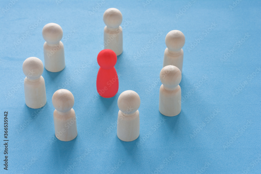 Obraz premium Red woman figure surrounded by circle of mans silhouettes on blue background. Gender discrimination and sexual violence concept. Female leader boss concept in a male team.