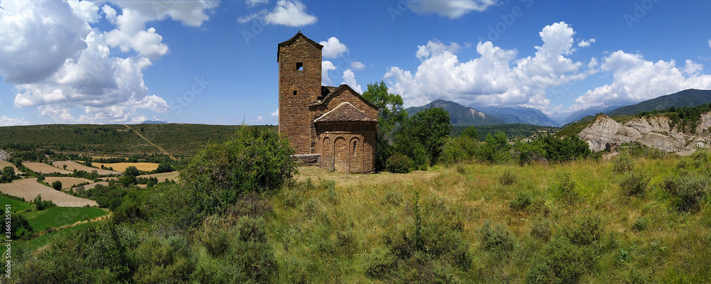 Fototapeta premium Landscape with view of the Romanesque Church of San Andres in the village of Satué. 11th century. Serrablo Region .Aragon. Spain.