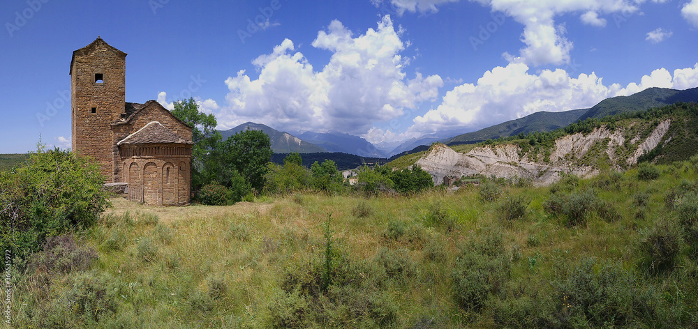 Fototapeta premium Landscape with view of the Romanesque Church of San Andres in the village of Satué. 11th century. Serrablo Region .Aragon. Spain.