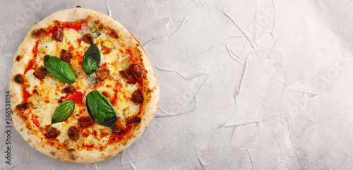 pizza with mushrooms, tomato and basil banner top view. pizza with mushrooms on light concrete or stone table