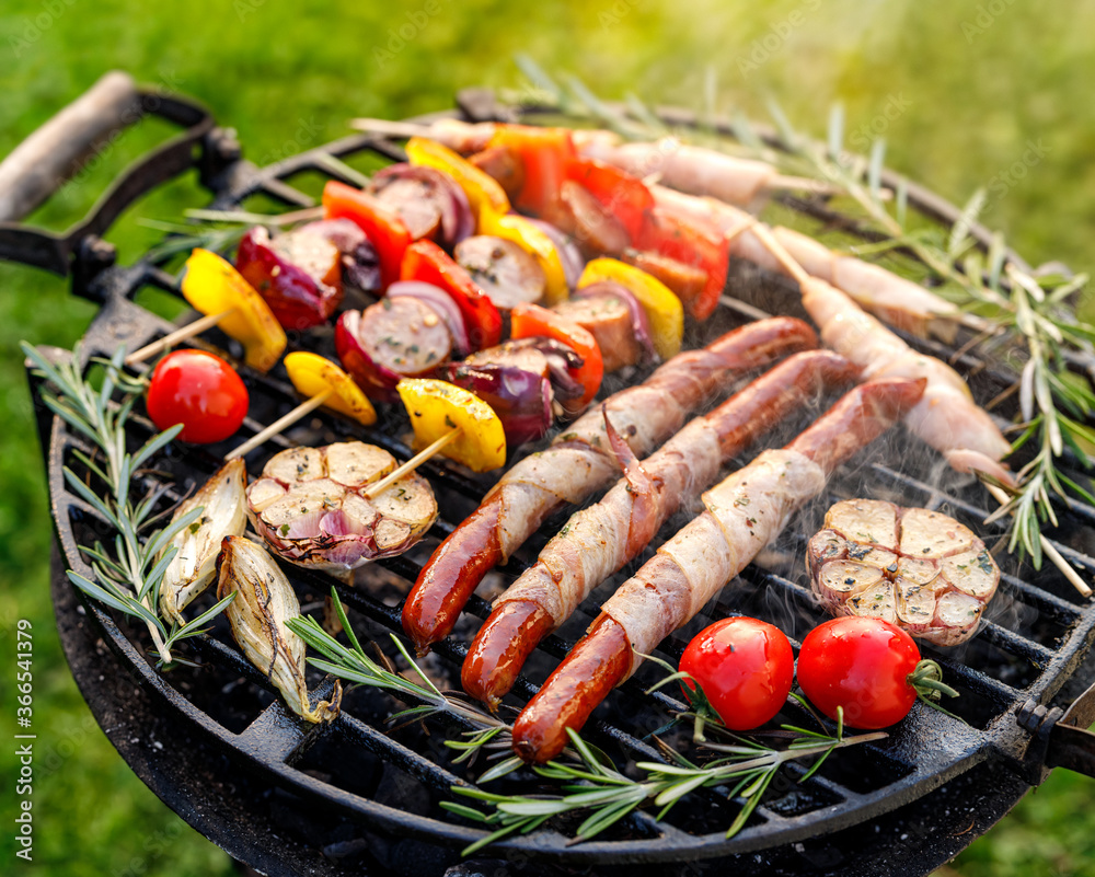 Grilled various food, sausages and vegetable and meat skewers with herbs on a cast iron grill
close up view Grilled various food, sausages and vegetable and meat skewers with herbs on a cast iron grill
close up view