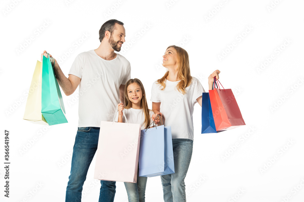 cheerful family with colorful shopping bags isolated on white