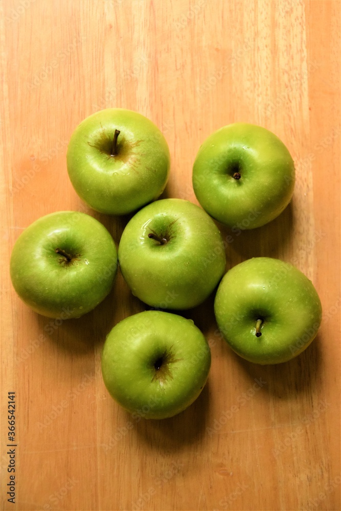 Six ripe green Granny Smith apples on wooden background Six ripe green Granny Smith apples on wooden background
