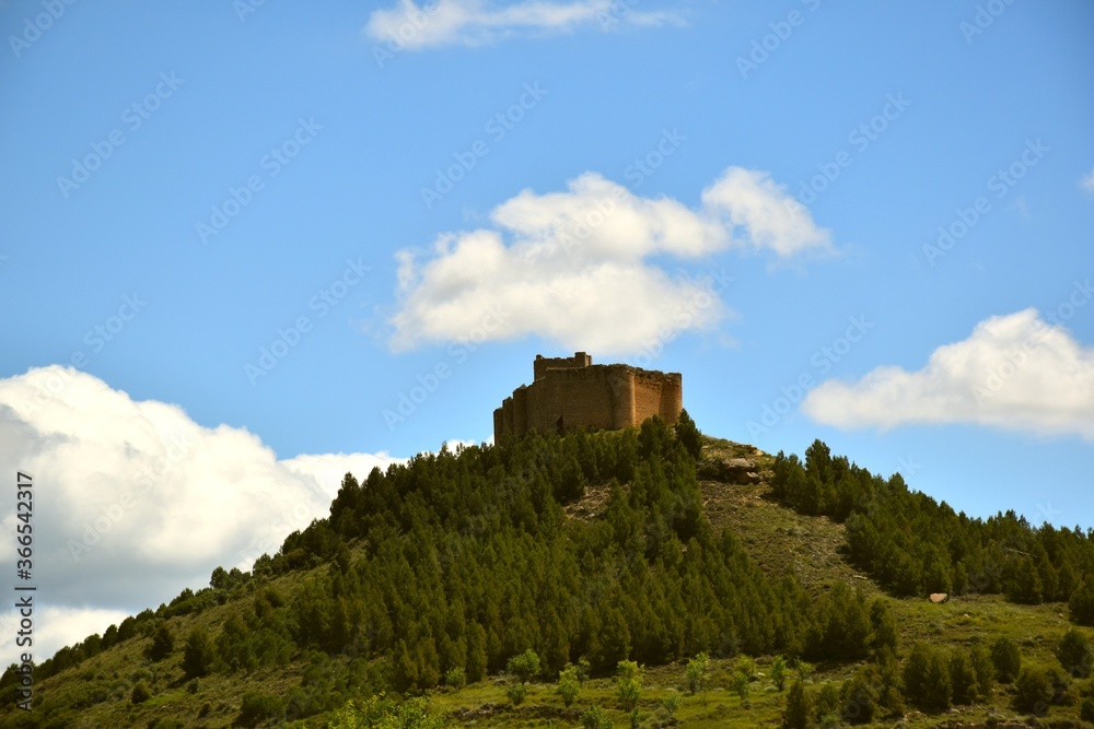 Davalillo Castle on top of the mountain with cloudy blue sky.