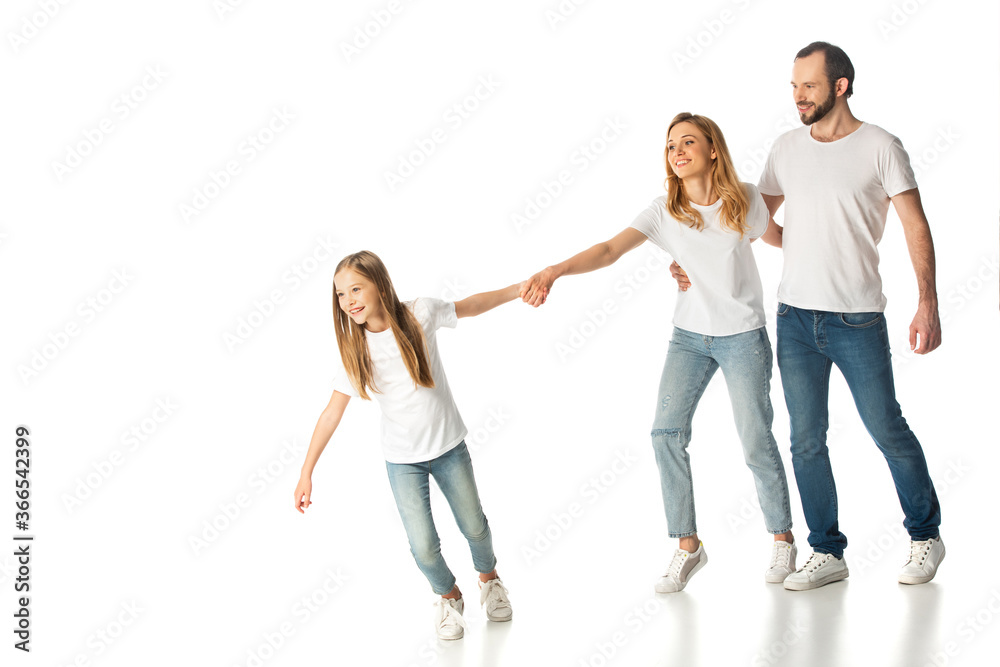 happy casual family holding hands while walking isolated on white happy casual family holding hands while walking isolated on white
