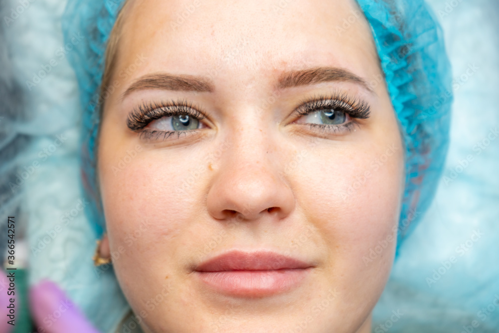 Beautiful woman making permanent makeup in cosmetology salon. Beautiful woman making permanent makeup in cosmetology salon.