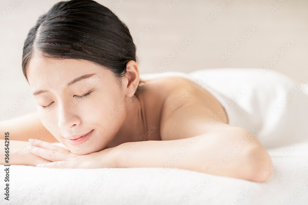 Young woman being massaged in a beauty salon with a bright atmosphere Young woman being massaged in a beauty salon with a bright atmosphere