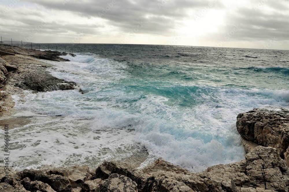 waves on the pebbles beach and stormy sky, horizon line waves on the pebbles beach and stormy sky, horizon line
