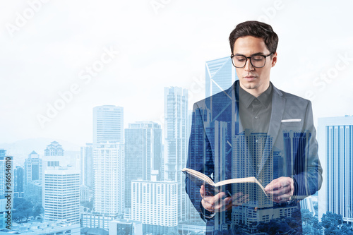 Canvas Print Young handsome businessman in suit and glasses thinking how to tackle the problem, new career opportunities, MBA assignment