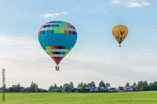 Hot air balloons over the countryside in summer © Ekaterina Senyutina