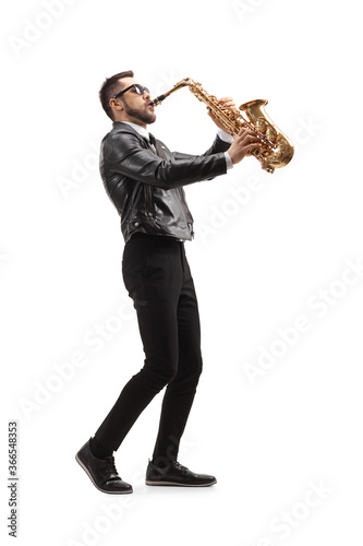 Full length profile shot of a musician playing a saxophone and wearing sunglasses
