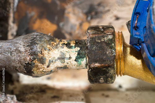 Foto old lead pipe to replace by professional plumber due to health hazard