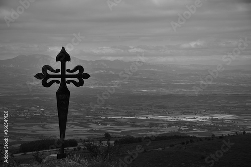 Cross of the apostle Santiago in the ruins of the Clavijo castle, symbol of the reconquest in the 12th century of Christians against Muslims. Views of the Ebro Valley. Black and white photo. photo