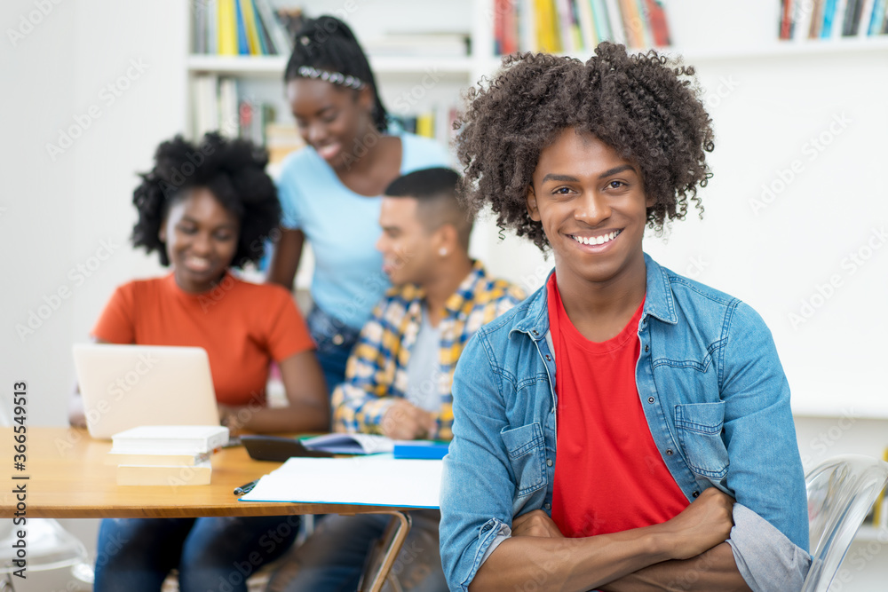 Young african american computer science student with group of students Young african american computer science student with group of students