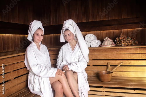 two young girls have a rest in a sauna