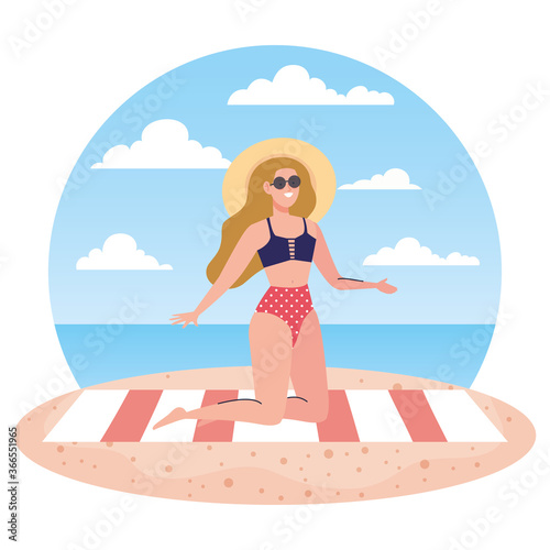 woman with swimsuit sitting on the towel, in the beach, holiday vacation season © Gstudio
