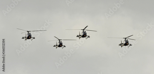 Fototapeta Naklejka Na Ścianę i Meble -  Four military helicopters are flying in formation