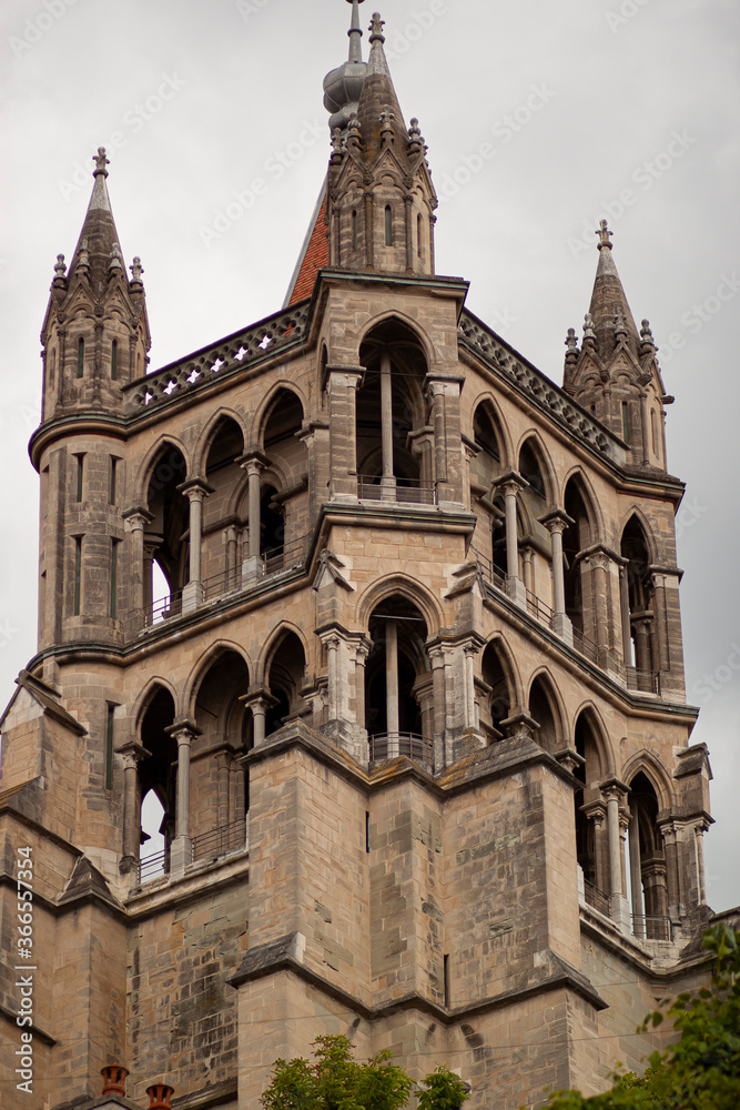 The tower building of the Cathedral of Notre Dame of Lausanne from distance. This isolated close up image shows details of the arched architecture of this medieval building