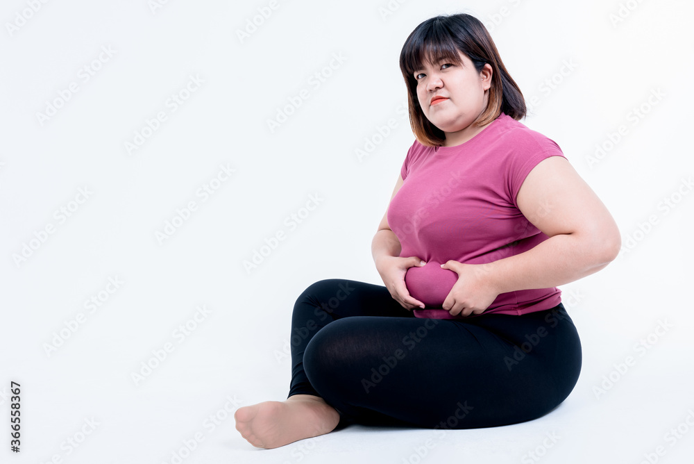 Portrait images of Fat woman sitting and using her hands to grasp the belly fat Which has its own size, On white background, to fat woman and health care concept. Portrait images of Fat woman sitting and using her hands to grasp the belly fat Which has its own size, On white background, to fat woman and health care concept.