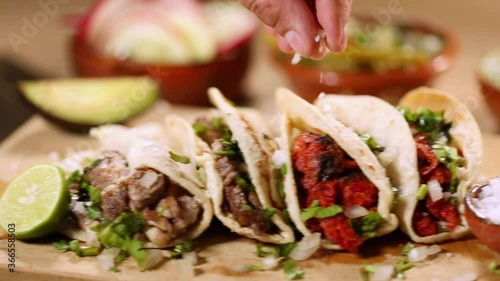 Man putting salt and lemon on his delicious tacos