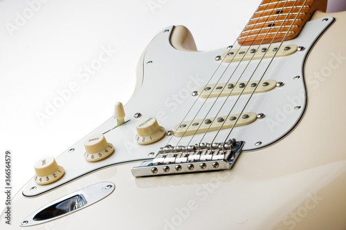 White electric guitar left handed on a white background.