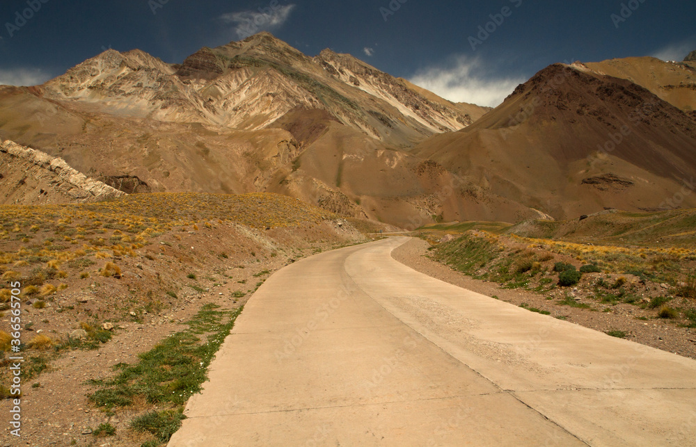 Travel. Empty desert road. Asphalt path across the arid valley and mountains. Travel. Empty desert road. Asphalt path across the arid valley and mountains.