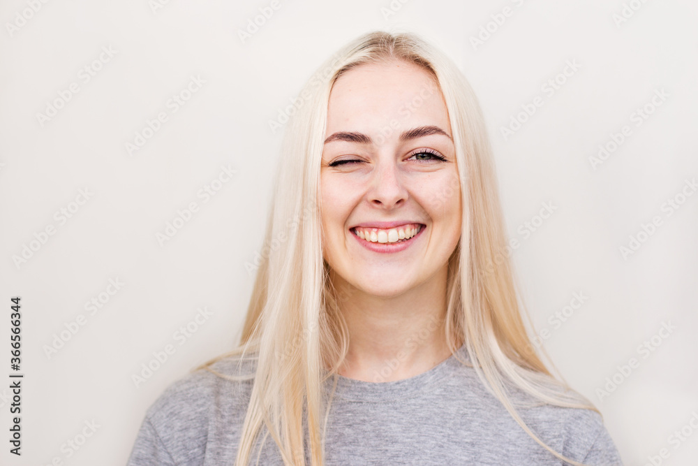 Pretty smiling joyfully female with fair hair, dressed casually, looking with satisfaction at camera, being happy. Studio shot of good-looking beautiful woman Pretty smiling joyfully female with fair hair, dressed casually, looking with satisfaction at camera, being happy. Studio shot of good-looking beautiful woman