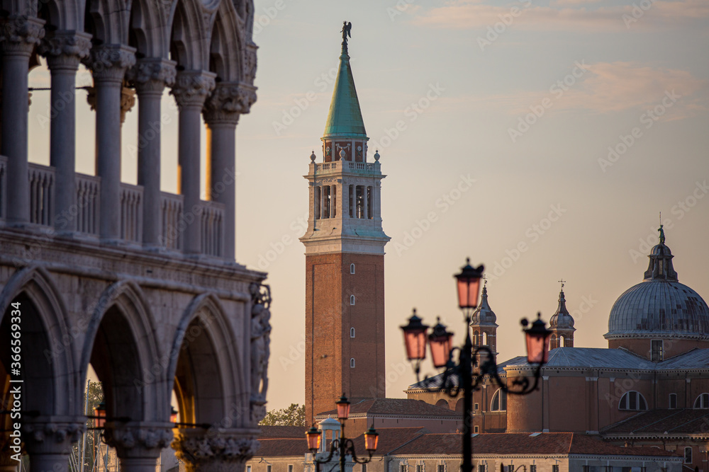 Golden hour light covers San Marco Square in Venice Italy Along Grand Canal with San Giorgio Maggiore in the background